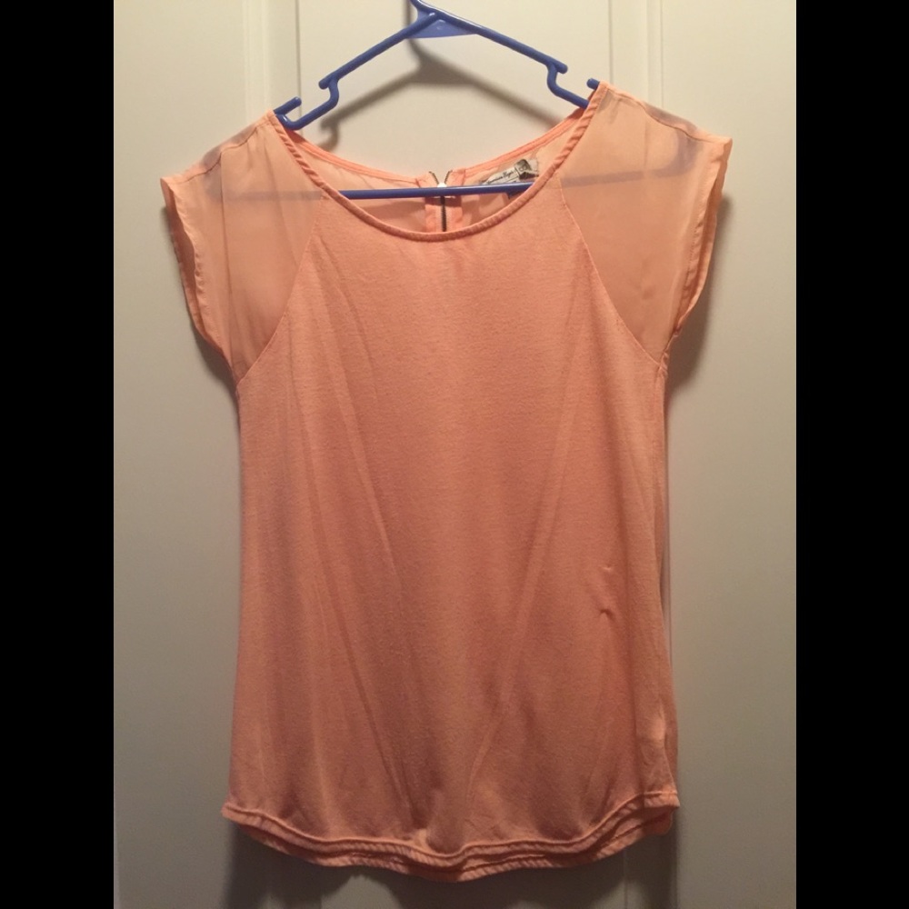 Peach colored top.